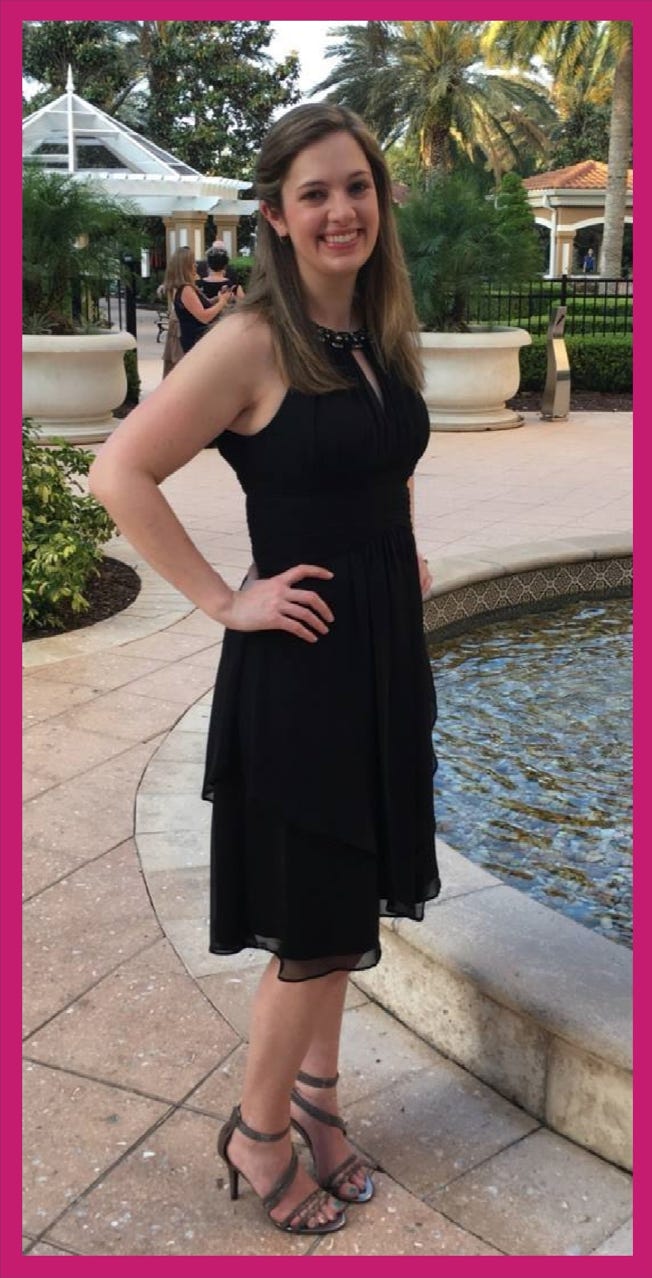 Mikaela after losing 82 pounds standing in front of a fountain by palm trees.